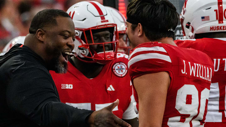 James Williams celebrates the Nebraska defense's final stop of the 2024 Rutgers game with defensive line  coach Terrance Knighton.   