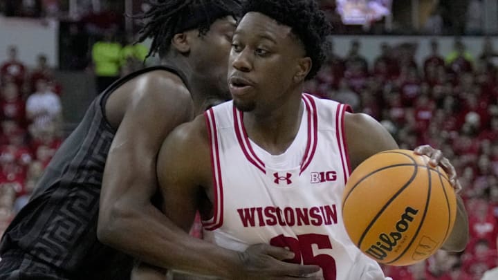 Wisconsin guard John Blackwell (25) drives on Michigan State guard Kur Teng (2) during the second half of their game Friday, February 13, 2026 at the Kohl Center in Madison, Wisconsin. Wisconsin beat 10th ranked Michigan State 92-71.