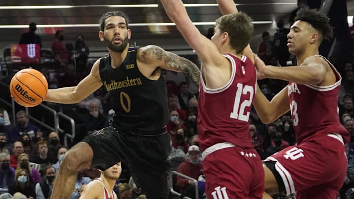 Northwestern Wildcats guard Boo Buie (0) looks to pass around Indiana Hoosiers forwards Miller Kopp (12) and Trayce Jackson-Davis (23) at Welsh-Ryan Arena. 