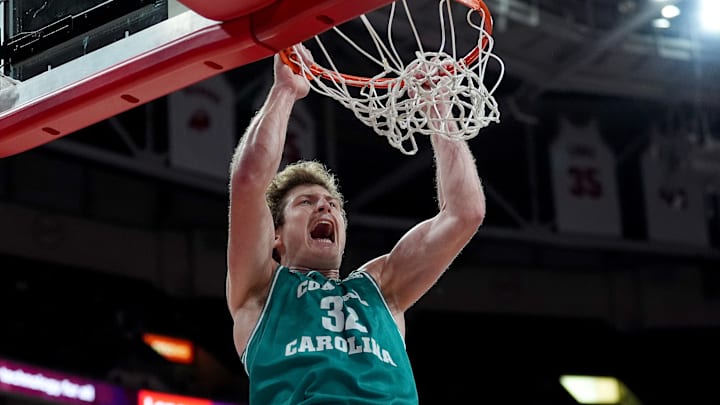 Colin Granger #32 of the Coastal Carolina Chanticleers dunks against the North Carolina State Wolfpack during the game at Lenovo Center on November 13, 2024 in Raleigh, North Carolina.