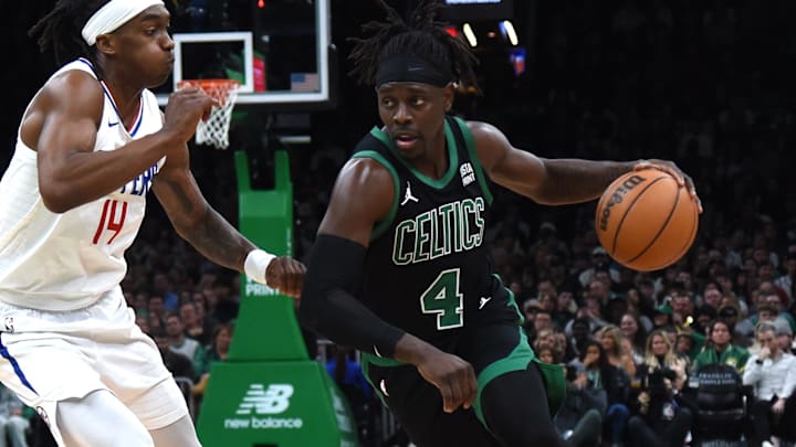 Jan 27, 2024; Boston, Massachusetts, USA;  Boston Celtics guard Jrue Holiday (4) controls the ball while LA Clippers guard Terance Mann (14) defends during the second half at TD Garden. Mandatory Credit: Bob DeChiara-Imagn Images