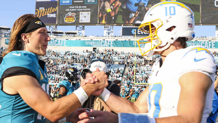 Nov 16, 2025; Jacksonville, Florida, USA; Jacksonville Jaguars quarterback Trevor Lawrence (16) shakes hands with Los Angeles Chargers quarterback Justin Herbert (10) following a Jaguars victory at EverBank Stadium. Mandatory Credit: Morgan Tencza-Imagn Images