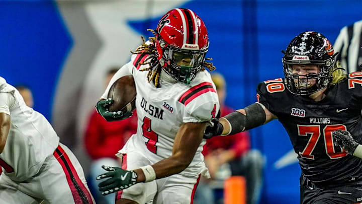 Orchard Lake St. Mary’s WR Bryson Williams (4) breaks through Byron Center’s defensive line during the first half of the Michigan High School Athletic Association division two football finals at Ford Field in Detroit on Friday, Nov. 29, 2024.