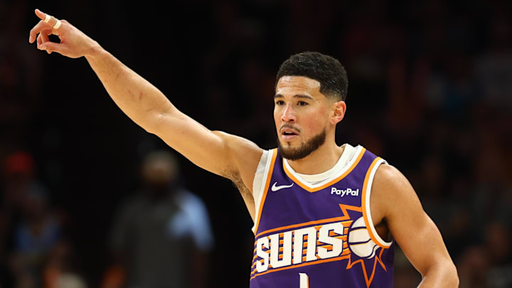 Mar 24, 2026; Phoenix, Arizona, USA; Phoenix Suns guard Devin Booker (1) reacts against the Denver Nuggets in the second half at Mortgage Matchup Center. Mandatory Credit: Mark J. Rebilas-Imagn Images