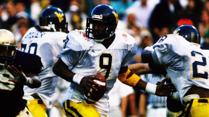 Jan 2, 1989; Tempe, AZ, USA; FILE PHOTO; Notre Dame Irish defensive tackle George Williams (69) pressures West Virginia Mountaineers quarterback Major Harris (9) during the 1989 National Championship Fiesta Bowl at Sun Devil Stadium. Notre Dame defeated West Virginia 34-21. Mandatory Credit: Malcolm Emmons-USA TODAY NETWORK