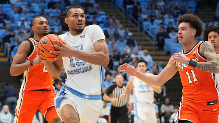 Feb 2, 2026; Chapel Hill, North Carolina, USA; North Carolina Tar Heels forward Jarin Stevenson (15) with the ball as Syracuse Orange guard JJ Starling (2) and guard Naithan George (11) defend in the second half at Dean E. Smith Center. Mandatory Credit: Bob Donnan-Imagn Images