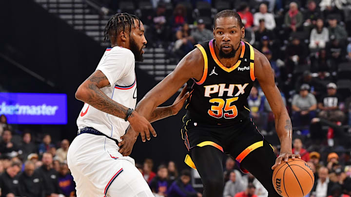 Oct 31, 2024; Inglewood, California, USA; Phoenix Suns forward Kevin Durant (35) moves the ball against Los Angeles Clippers forward Derrick Jones Jr. (55) during the first half at Intuit Dome. Mandatory Credit: Gary A. Vasquez-Imagn Images