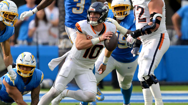 Sep 21, 2025; Inglewood, California, USA;  Denver Broncos quarterback Bo Nix (10) scrambles in the pocket in the second half against the Los Angeles Chargers at SoFi Stadium.