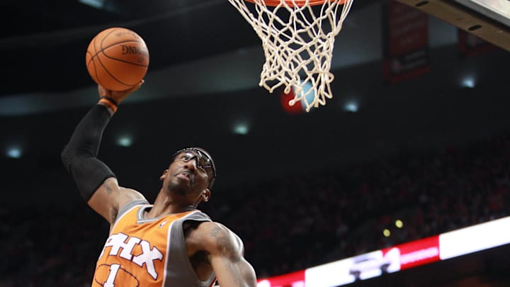 Former Phoenix Suns forward Amare Stoudemire dunks over Portland Trail Blazers forward Juwan Howard at the Rose Garden.