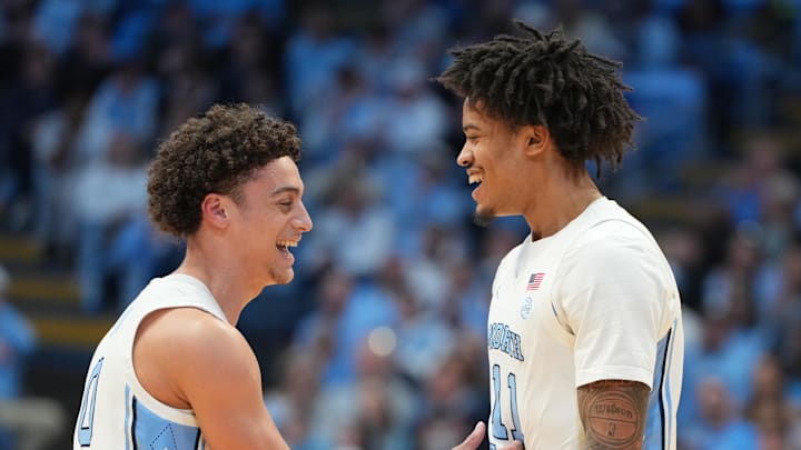 Feb 2, 2026; Chapel Hill, North Carolina, USA;  North Carolina Tar Heels guard Kyan Evans (0) and forward Jonathan Powell (11) react in the first half at Dean E. Smith Center. Mandatory Credit: Bob Donnan-Imagn Images