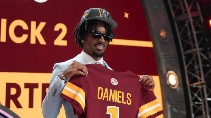 Apr 25, 2024; Detroit, MI, USA; LSU Tigers quarterback Jayden Daniels poses after being selected by the Washington Commanders as the No. 2 pick in the first round of the 2024 NFL Draft at Campus Martius Park and Hart Plaza. Mandatory Credit: Kirby Lee-USA TODAY Sports Apr 25, 2024; Detroit, MI, USA; LSU Tigers quarterback Jayden Daniels poses after being selected by the Washington Commanders as the No. 2 pick in the first round of the 2024 NFL Draft at Campus Martius Park and Hart Plaza. Mandatory Credit: Kirby Lee-USA TODAY Sports