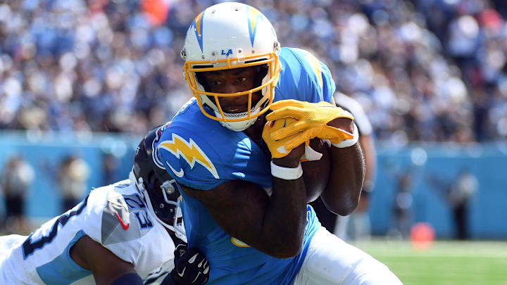 Sep 17, 2023; Nashville, Tennessee, USA; Los Angeles Chargers wide receiver Mike Williams (81) runs after a catch against Tennessee Titans cornerback Tre Avery (23) during the first half at Nissan Stadium. Mandatory Credit: Christopher Hanewinckel-Imagn Images