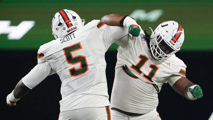 Dec 31, 2025; Arlington, TX, USA; Miami Hurricanes defensive lineman Justin Scott (5) and defensive lineman David Blay, Jr. (11) celebrates in the second quarter during the 2025 Cotton Bowl and quarterfinal game of the College Football Playoff at AT&T Stadium. Mandatory Credit: Raymond Carlin III-Imagn Images Dec 31, 2025; Arlington, TX, USA; Miami Hurricanes defensive lineman Justin Scott (5) and defensive lineman David Blay, Jr. (11) celebrates in the second quarter during the 2025 Cotton Bowl and quarterfinal game of the College Football Playoff at AT&T Stadium. Mandatory Credit: Raymond Carlin III-Imagn Images
