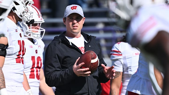 Wisconsin Badgers interim head coach Jim Leonhard watches his team warm up before a game against the Northwestern Wildcats