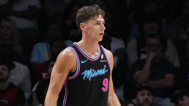 Mar 14, 2026; Miami, Florida, USA;  Orlando Magic guard Jalen Suggs (4) lies on the court as Miami Heat guard Pelle Larsson (9) looks on during the second half at Kaseya Center. Mandatory Credit: Jim Rassol-Imagn Images