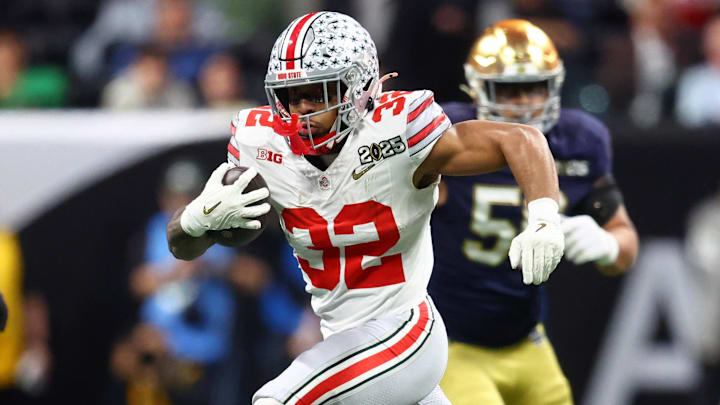 Jan 20, 2025; Atlanta, GA, USA; Ohio State Buckeyes running back TreVeyon Henderson (32) runs with the ball against the Notre Dame Fighting Irish during the first half the CFP National Championship college football game at Mercedes-Benz Stadium. Mandatory Credit: Mark J. Rebilas-Imagn Images