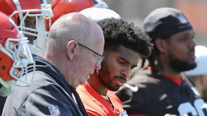 Cleveland Browns quarterbacks coach Bill Musgrave, left, works with quarterback Shedeur Sanders (12) during NFL rookie minicamp at the Cleveland Browns training facility on Friday, May 9, 2025, in Berea, Ohio.