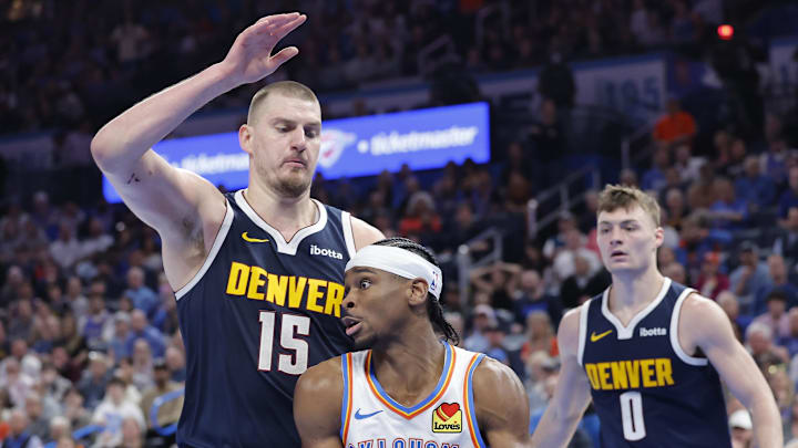 Mar 10, 2025; Oklahoma City, Oklahoma, USA; Denver Nuggets center Nikola Jokic (15) defends a drive by Oklahoma City Thunder guard Shai Gilgeous-Alexander (2) during the second half at Paycom Center. Mandatory Credit: Alonzo Adams-Imagn Images Mar 10, 2025; Oklahoma City, Oklahoma, USA; Denver Nuggets center Nikola Jokic (15) defends a drive by Oklahoma City Thunder guard Shai Gilgeous-Alexander (2) during the second half at Paycom Center. Mandatory Credit: Alonzo Adams-Imagn Images