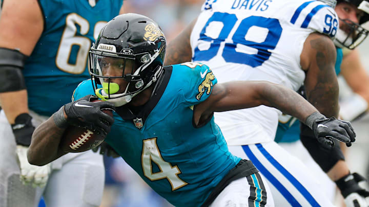 Jacksonville Jaguars running back Tank Bigsby (4) rushes for yards during the fourth quarter of an NFL football matchup Sunday, Oct. 6, 2024 at EverBank Stadium in Jacksonville, Fla. The Jaguars edged the Colts on a field goal 37-34. [Corey Perrine/Florida Times-Union]