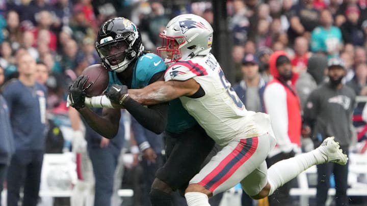 Oct 20, 2024; London, United Kingdom; Jacksonville Jaguars wide receiver Brian Thomas Jr. (7) catches a 58-yard pass against New England Patriots cornerback Christian Gonzalez (0) in the first half of an NFL International Series game at Wembley Stadium. Mandatory Credit: Kirby Lee-Imagn Images