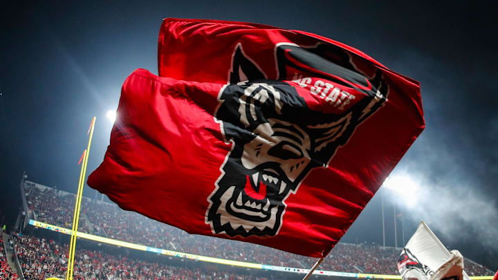 Nov 21, 2025; Raleigh, North Carolina, USA;  NC State Wolfpack cheerleader celebrates a touchdown during the second half of the game against Florida State Seminoles at Carter-Finley Stadium. Mandatory Credit: Jaylynn Nash-Imagn Images