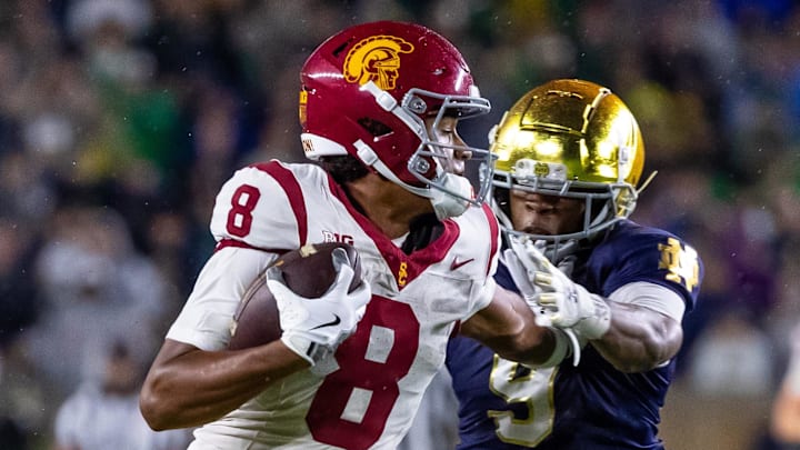 Oct 18, 2025; South Bend, Indiana, USA; Southern California Trojans wide receiver Ja'Kobi Lane (8) breaks a tackle by Notre Dame Fighting Irish safety Tae Johnson (9) during the second half at Notre Dame Stadium. Mandatory Credit: Michael Caterina-Imagn Images