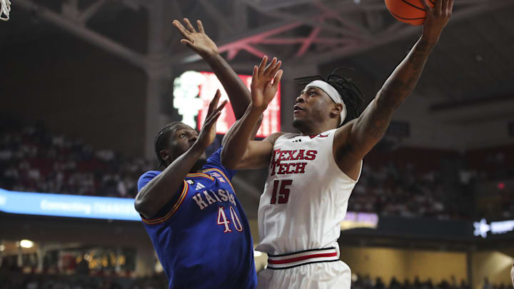 Texas Tech Red Raiders forward JT Toppin (15) shoots over Kansas Jayhawks forward Flory Bidunga (40) in the second half at United Supermarkets Arena.