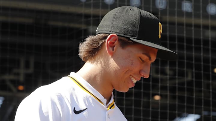 Jul 22, 2025; Pittsburgh, Pennsylvania, USA;  Seth Hernandez (left) the Pittsburgh Pirates first round and number six overall pick in the 2025 first year player draft looks at the glove of Pirates pitcher Paul Skenes (30) before the game against the Detroit Tigers at PNC Park. Mandatory Credit: Charles LeClaire-Imagn Images