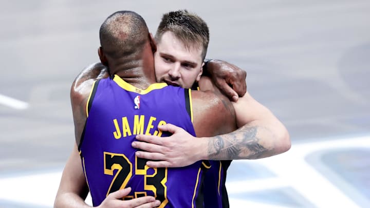 Los Angeles Lakers guard Doncic celebrates with Los Angeles Lakers forward James during the fourth quarter against the Dallas Mavericks at American Airlines Center. 