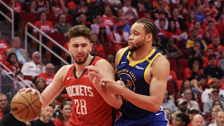 Apr 30, 2025; Houston, Texas, USA; Houston Rockets center Alperen Sengun (28) dribbles against Golden State Warriors forward Kevin Knox II (31) in the fourth quarter during game five of first round for the 2025 NBA Playoffs at Toyota Center. Mandatory Credit: Thomas Shea-Imagn Images