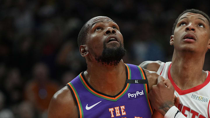 Mar 30, 2025; Phoenix, Arizona, USA; Phoenix Suns forward Kevin Durant (35) and Houston Rockets forward Jabari Smith Jr. (10) fight for position in the first half at Footprint Center. Mandatory Credit: Rick Scuteri-Imagn Images