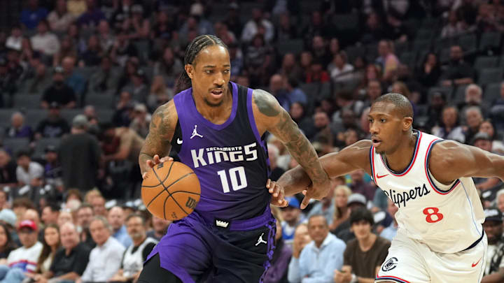 Apr 11, 2025; Sacramento, California, USA; Sacramento Kings forward DeMar DeRozan (10) dribbles against Los Angeles Clippers guard Kris Dunn (8) during the first quarter at Golden 1 Center. 