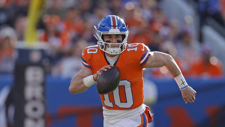 Jan 4, 2026; Denver, Colorado, USA; Denver Broncos quarterback Bo Nix (10) runs with the ball against the Los Angeles Chargers during the first half at Empower Field at Mile High. 