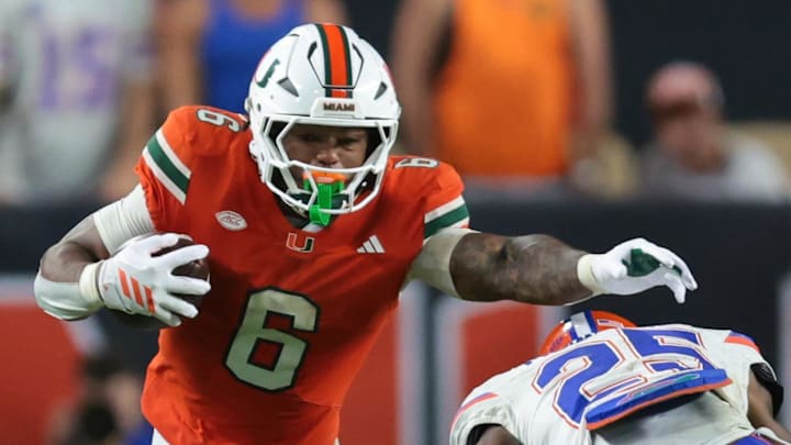 Sep 20, 2025; Miami Gardens, Florida, USA; Miami Hurricanes running back CharMar Brown (6) carries the football against Florida Gators defensive back Cormani McClain (25) during the fourth quarter at Hard Rock Stadium. Mandatory Credit: Sam Navarro-Imagn Images
