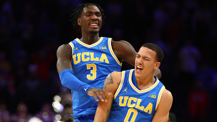 Dec 14, 2024; Phoenix, Arizona, USA; UCLA Bruins guard Kobe Johnson (0) celebrates with Eric Dailey Jr. (3) after defeating the Arizona Wildcats at Footprint Center. Mandatory Credit: Mark J. Rebilas-Imagn Images