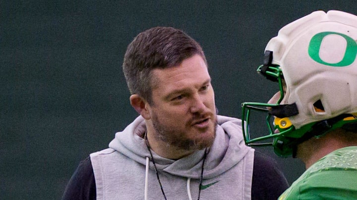 Oregon head coach Dan Lanning, left, talks to Oregon defensive back Dillon Thieneman during an open practice ahead of the Orange Bowl at the Moshofsky Center in Eugene, Oregon on Dec. 27, 2025.