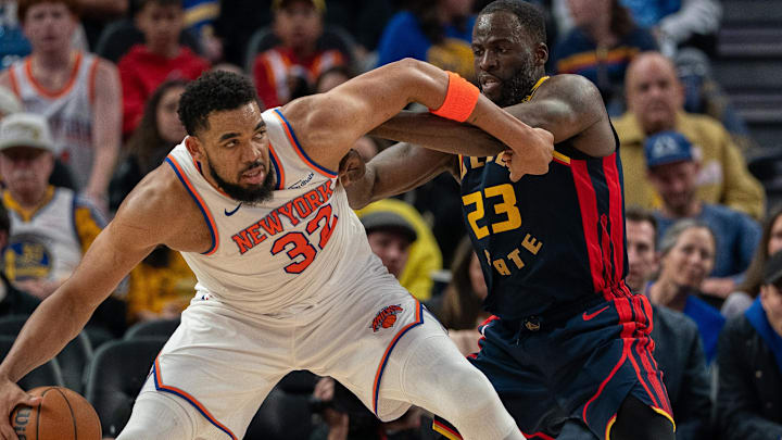 Mar 15, 2025; San Francisco, California, USA; New York Knicks center Karl-Anthony Towns (32) controls the basketball against Golden State Warriors forward Draymond Green (23) during the third quarter at Chase Center. Mandatory Credit: Neville E. Guard-Imagn Images