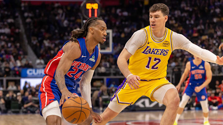 Mar 23, 2026; Detroit, Michigan, USA; Los Angeles Lakers Jake LaRavia (12) defends against Detroit Pistons Daniss Jenkins (24) during the second half at Little Caesars Arena. Mandatory Credit: David Reginek-Imagn Images Mar 23, 2026; Detroit, Michigan, USA; Los Angeles Lakers Jake LaRavia (12) defends against Detroit Pistons Daniss Jenkins (24) during the second half at Little Caesars Arena. Mandatory Credit: David Reginek-Imagn Images