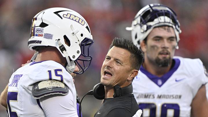 Sep 5, 2025; Louisville, Kentucky, USA;  James Madison Dukes head coach Bob Chesney talks with tight end Lacota Dippre (15) during the first quarter against the Louisville Cardinals at L&N Federal Credit Union Stadium. Mandatory Credit: Jamie Rhodes-Imagn Images