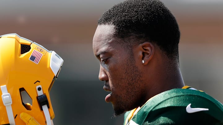 Green Bay Packers linebacker Quay Walker (7) puts his helmet back on during training camp.