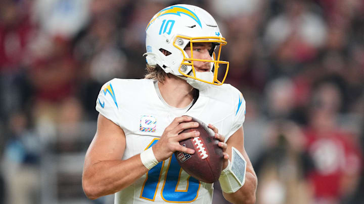 Oct 21, 2024; Glendale, Arizona, USA; Los Angeles Chargers quarterback Justin Herbert (10) drops back to pass against the Arizona Cardinals during the first half at State Farm Stadium. Mandatory Credit: Joe Camporeale-Imagn Images
