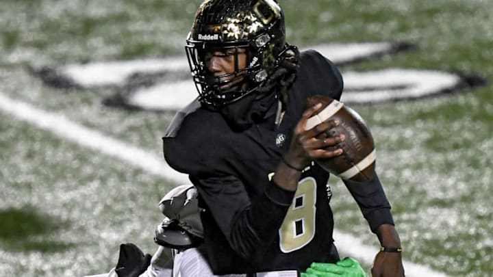 Gaffney quarterback Jayvon Gilmore (8) runs from TL Hanna junior Jameerion Oliver (0) during the second quarter of State Class 5A football playoffs at Gaffney High School in Gaffney, S.C. Friday, November 29, 2024.