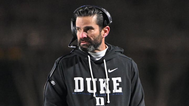 Nov 29, 2025; Durham, North Carolina, USA; Duke Blue Devils head coach Manny Diaz looks on against the Wake Forest Demon Deacons during the fourth quarter at Wallace Wade Stadium. Mandatory Credit: Zachary Taft-Imagn Images Nov 29, 2025; Durham, North Carolina, USA; Duke Blue Devils head coach Manny Diaz looks on against the Wake Forest Demon Deacons during the fourth quarter at Wallace Wade Stadium. Mandatory Credit: Zachary Taft-Imagn Images