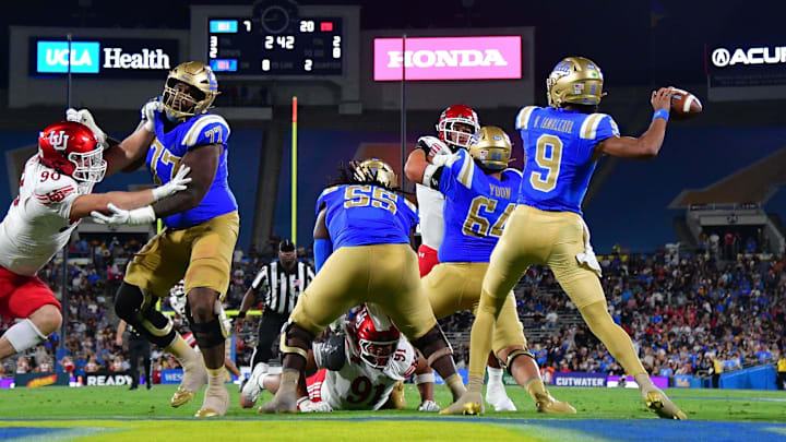 Aug 30, 2025; Pasadena, California, USA; UCLA Bruins quarterback Nico Iamaleava (9) throws as offensive lineman Courtland Ford (77) provides coverage against Utah Utes defensive end John Henry Daley (90) during the first half at Rose Bowl. Mandatory Credit: Gary A. Vasquez-Imagn Images Aug 30, 2025; Pasadena, California, USA; UCLA Bruins quarterback Nico Iamaleava (9) throws as offensive lineman Courtland Ford (77) provides coverage against Utah Utes defensive end John Henry Daley (90) during the first half at Rose Bowl. Mandatory Credit: Gary A. Vasquez-Imagn Images