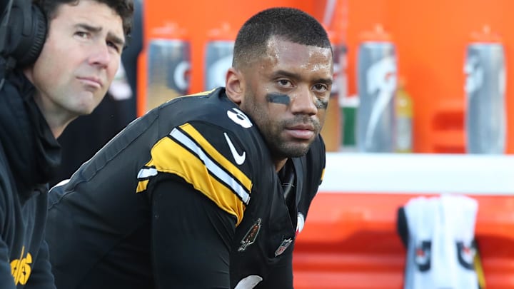 Dec 8, 2024; Pittsburgh, Pennsylvania, USA;  Pittsburgh Steelers quarterbacks coach Tom Arth (left) and quarterback Russell Wilson (3) look on from the bench against the cle/ during the third quarter at Acrisure Stadium. Mandatory Credit: Charles LeClaire-Imagn Images
