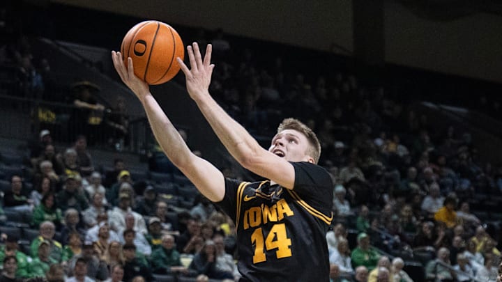 Iowa’s Bennett Stirtz, center, goes up for a shot against Oregon during the first half at Matthew Knight Arena in Eugene Feb 1, 2026.