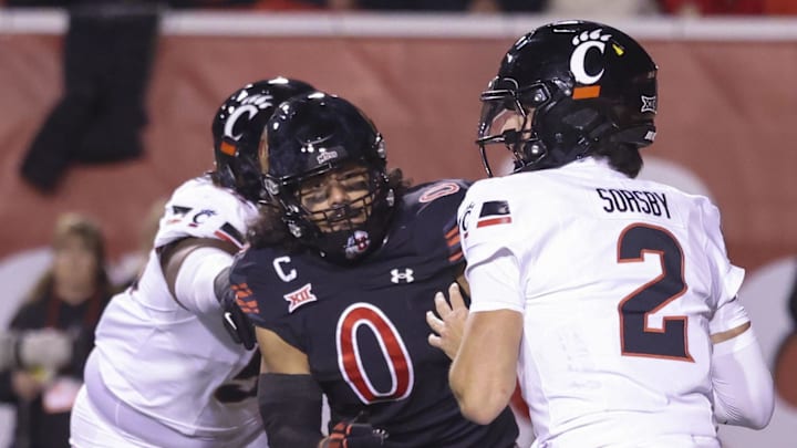 Cincinnati Bearcats quarterback Brendan Sorsby (2) is pressured by Utah Utes defensive end Logan Fano 