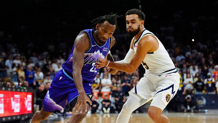 Oct 4, 2026; Boulder, Colorado, USA;  Utah Jazz guard Darryn Peterson (22) drives past Denver Nuggets guard Tyus Jones (5) in the first quarter at CU Events Center.  Mandatory Credit: Ron Chenoy-Imagn Images