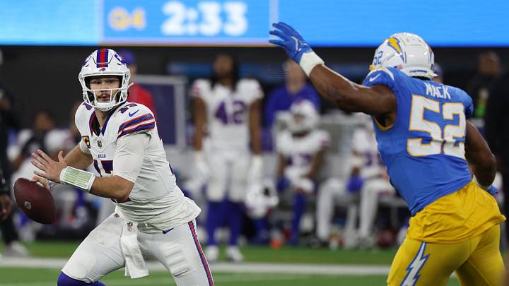Dec 23, 2023; Inglewood, California, USA;  Buffalo Bills quarterback Josh Allen (17) scrambles while Los Angeles Chargers linebacker Khalil Mack (52) pressuring him during the fourth quarter at SoFi Stadium. Mandatory Credit: Kiyoshi Mio-USA TODAY Sports