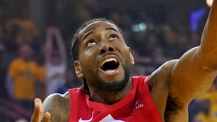 Toronto Raptors forward Kawhi Leonard shoots the ball against Golden State Warriors center Andrew Bogut.